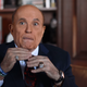 Rudy Giuliani (seen here with corpse hands).